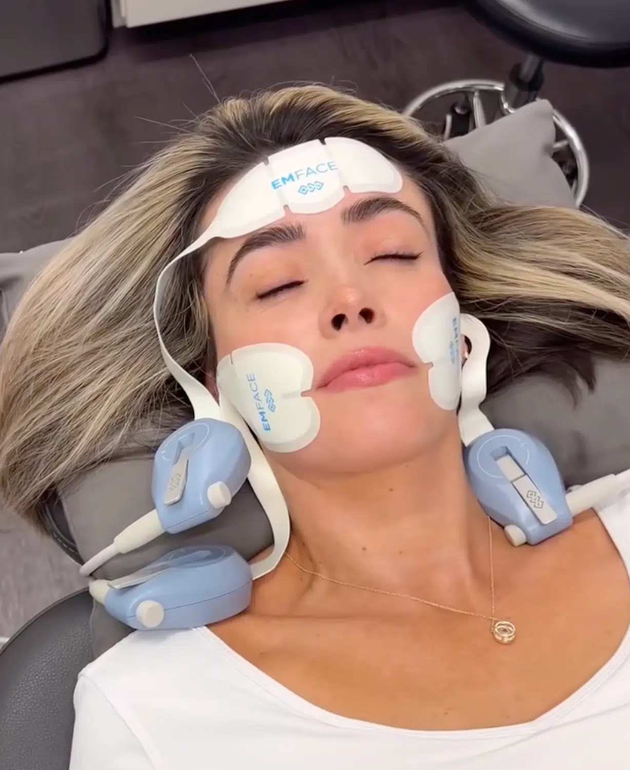 woman receiving emsculpt face treatment at bcrn