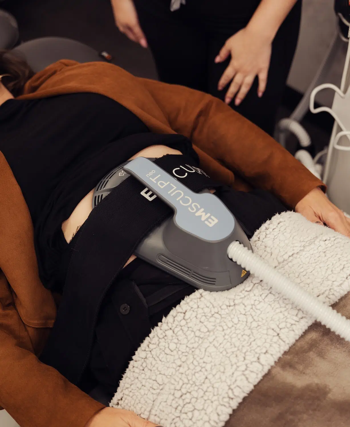 woman receiving emsculpt treatment at bcrn