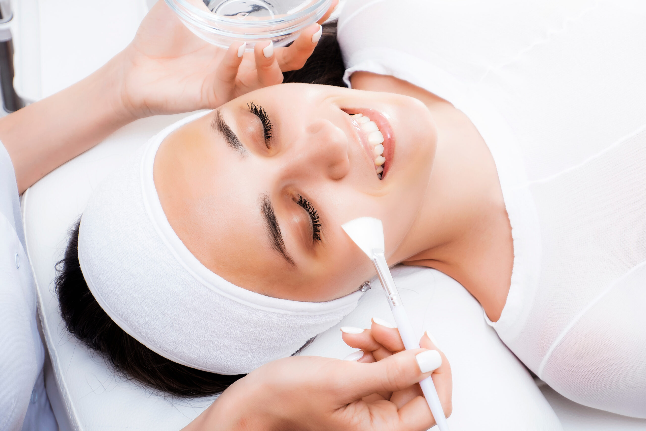 Face peeling at the beautician. Facial treatments. Photo chemical, glycolic, almond peeling.