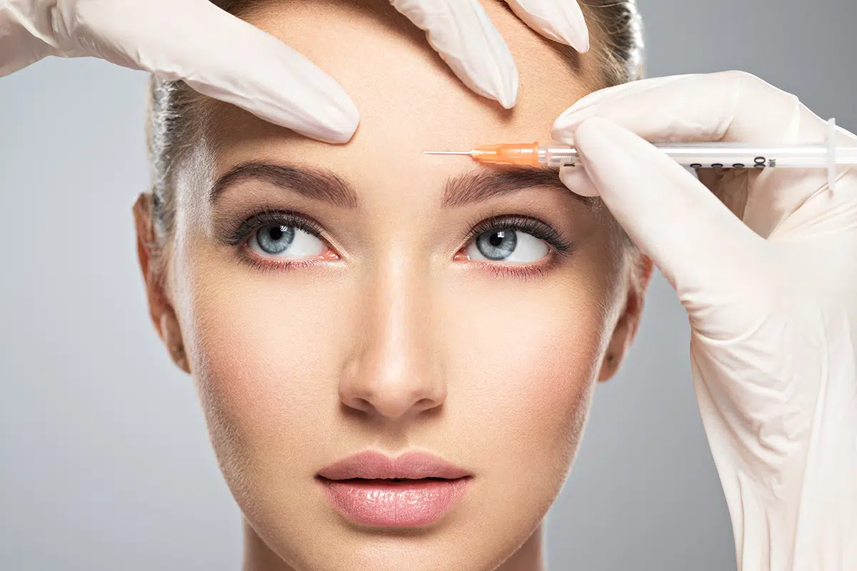 woman getting cosmetic botox injection in forehead woman getting cosmetic botox injection in forehead