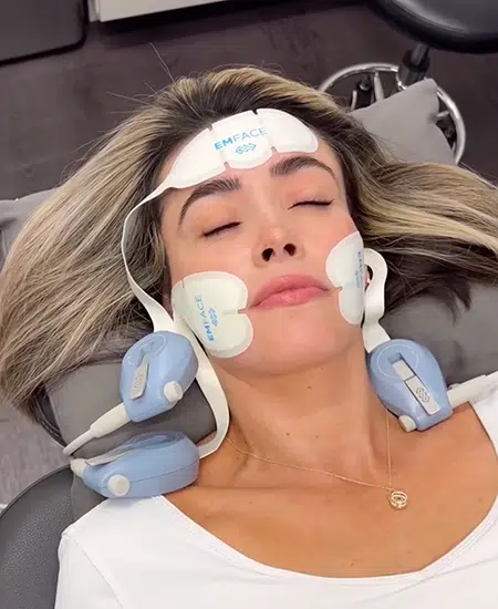 woman receiving emsculpt face treatment at bcrn